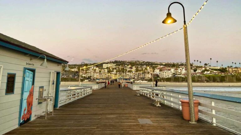 View of a boardwalk and city lights on a beach