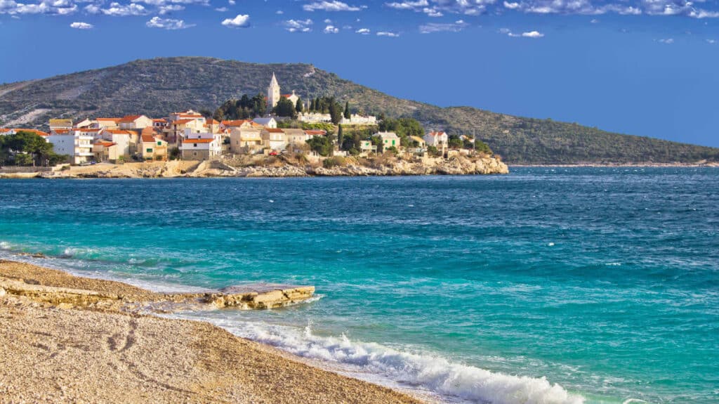 View of blue water from a beach near Primosten