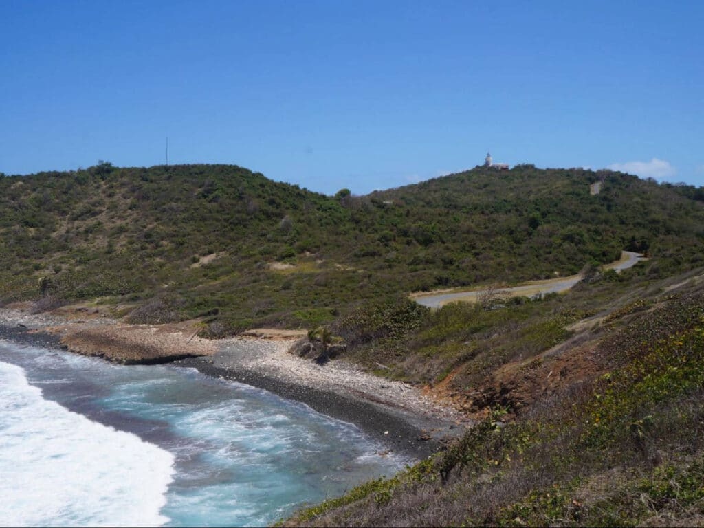 Aerial view of a beach and a lighthouse from afar in Fajardo