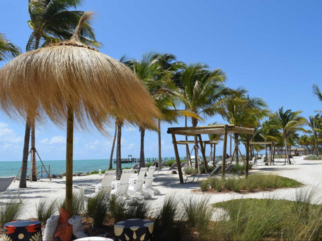 Panoramic view of the white sand beach and lounge area at the Islander Resort