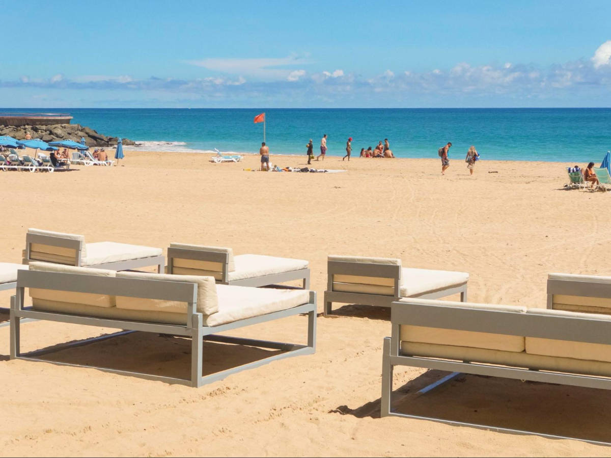 Empty beach beds in Condado Beach