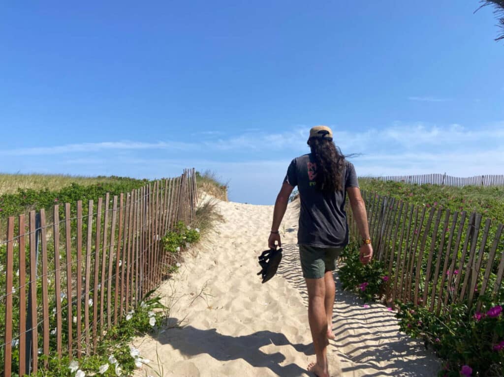 The author's friend walking to the beach