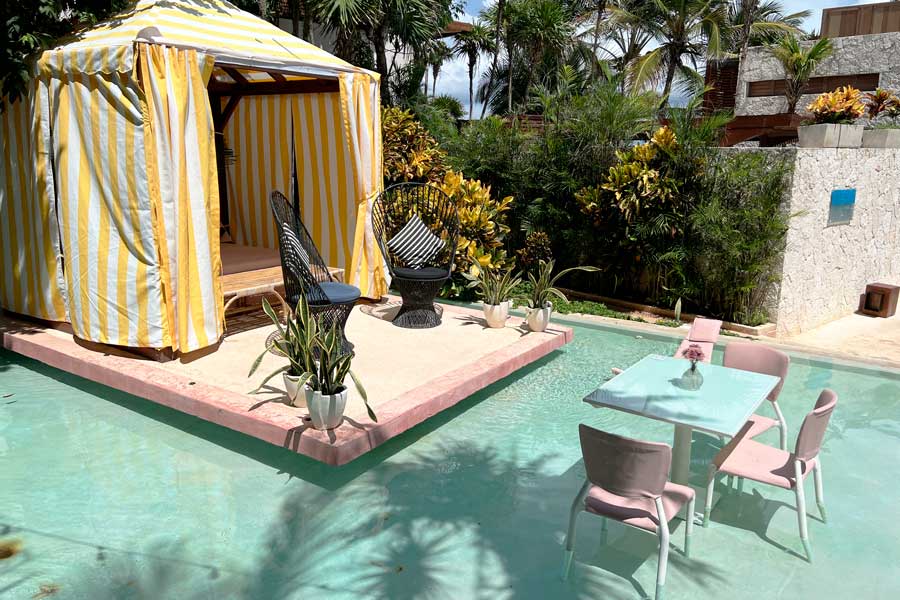 Chairs ad table on a pool in Mi Amor a Colibri Boutique Hotel