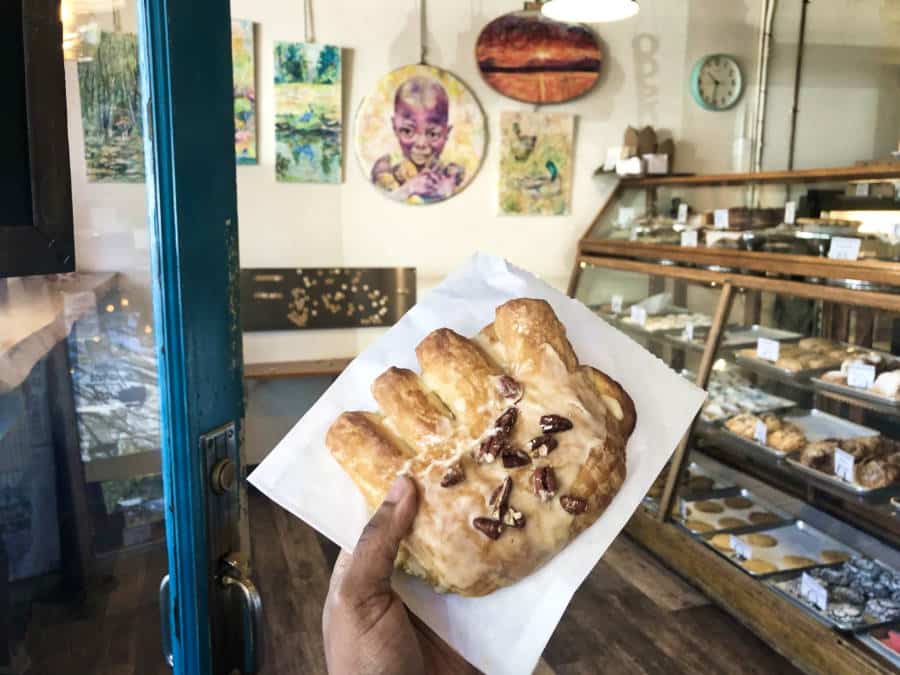 A hand holding the bear claw bread from Vashon Baking Company