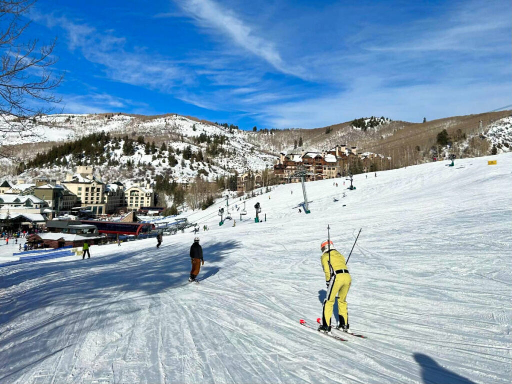 View of the skiers and the lodging beneath the picturesque mountain views at Beaver Creek Resort