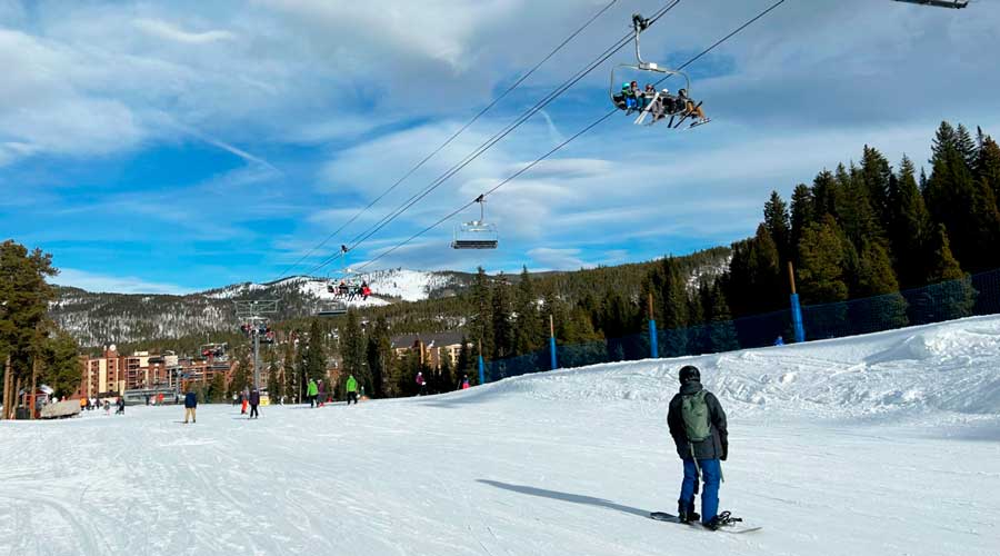 People skiing under the ski lift in Beaver Run Resort