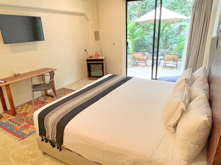 View of bed in hotel room at Naala Tulum
