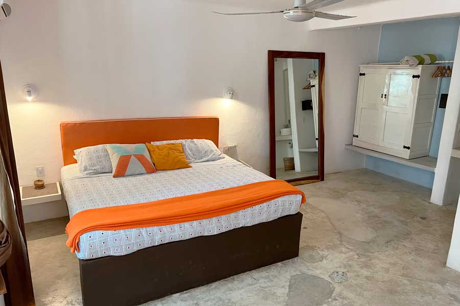 View of a bed inside a room in Teetotum Hotel