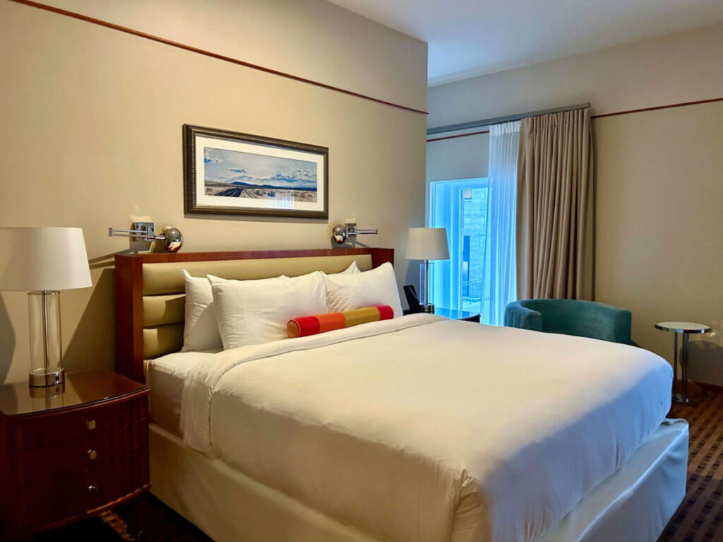 Hotel room featuring a king bed, desk, and chair