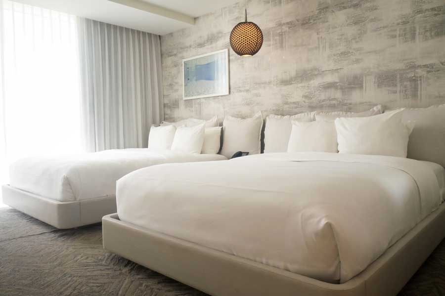 Two beds inside a room in Condado Ocean Club