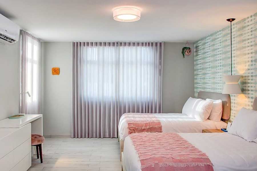 Two beds inside a room in Trópica Beach Hotel