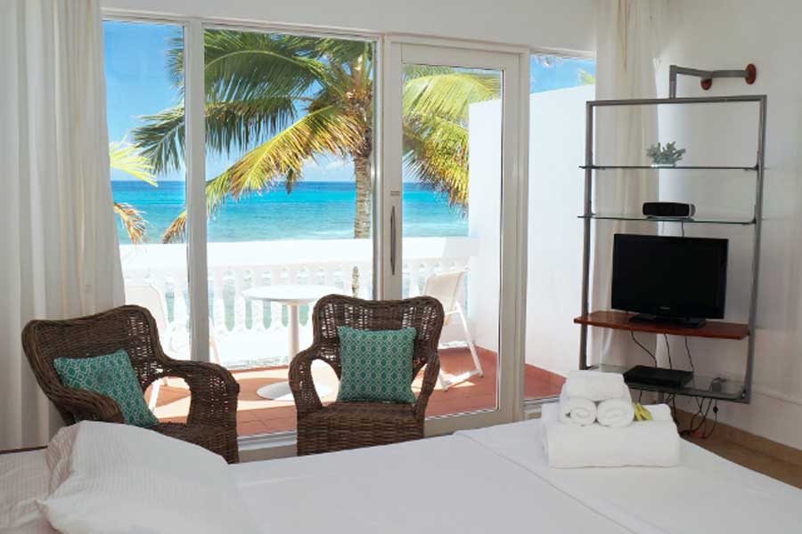 A bedroom with balcony and beach view in Bravo Beach Hotel