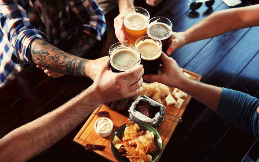 A group of friends having a toast with their glasses of beer