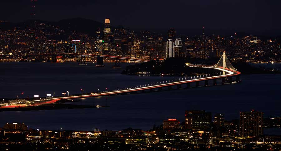 View of buildings with lights at night in San Francisco Bay Area from Berkeley Hills