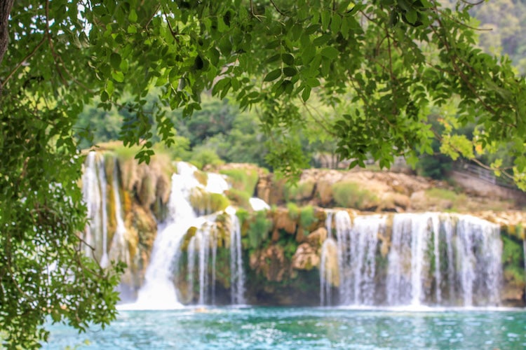 One of the main waterfalls in Krka National Park, surrounded by foliage