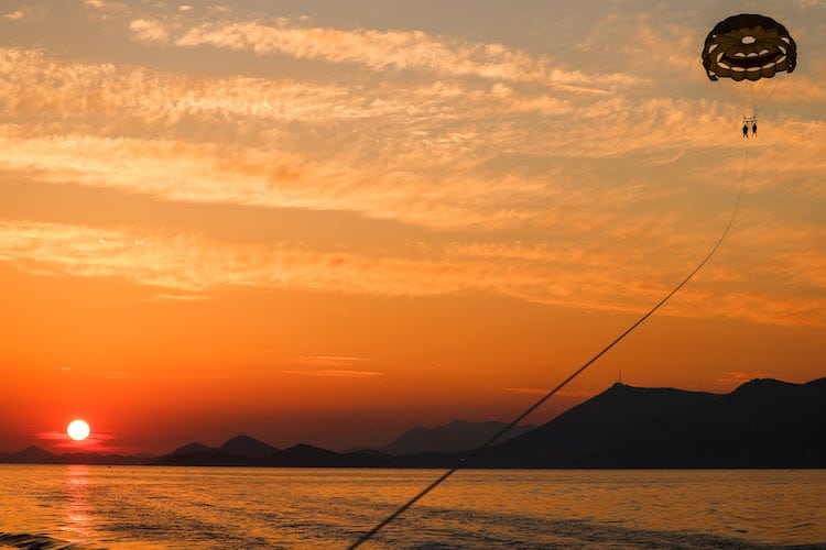 Parasailing in Cavtat during sunset with a red sky