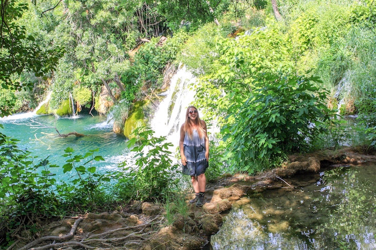 Taylor stands in front of a waterfall in Krka National park.