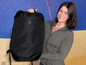 The author Betty Hurd holding a Tortuga Travel Backpack