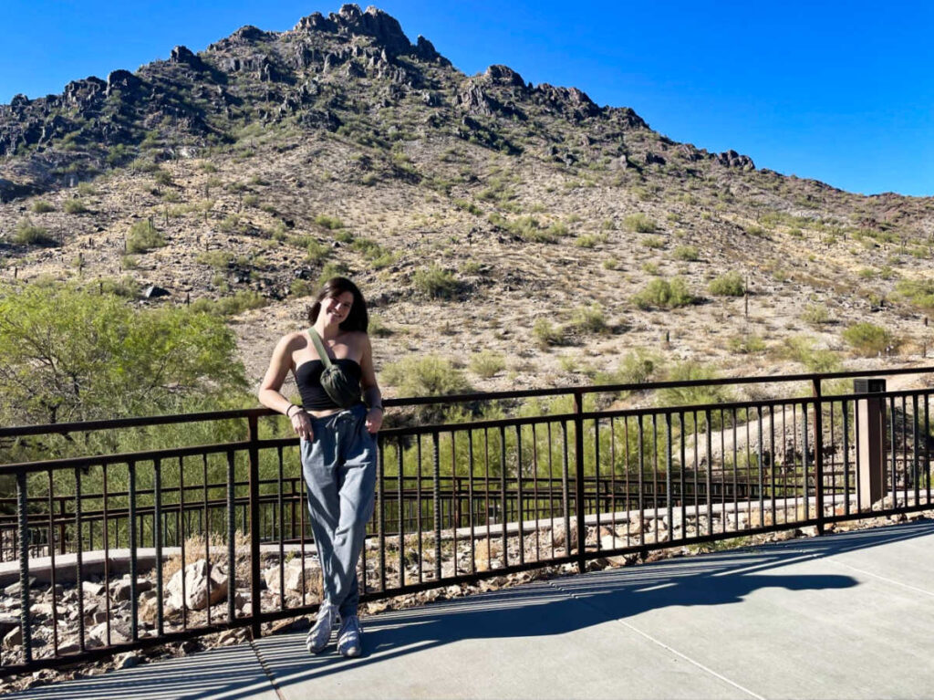 The author Betty Hurd, posing at the trail in front of the Piestewa Peak
