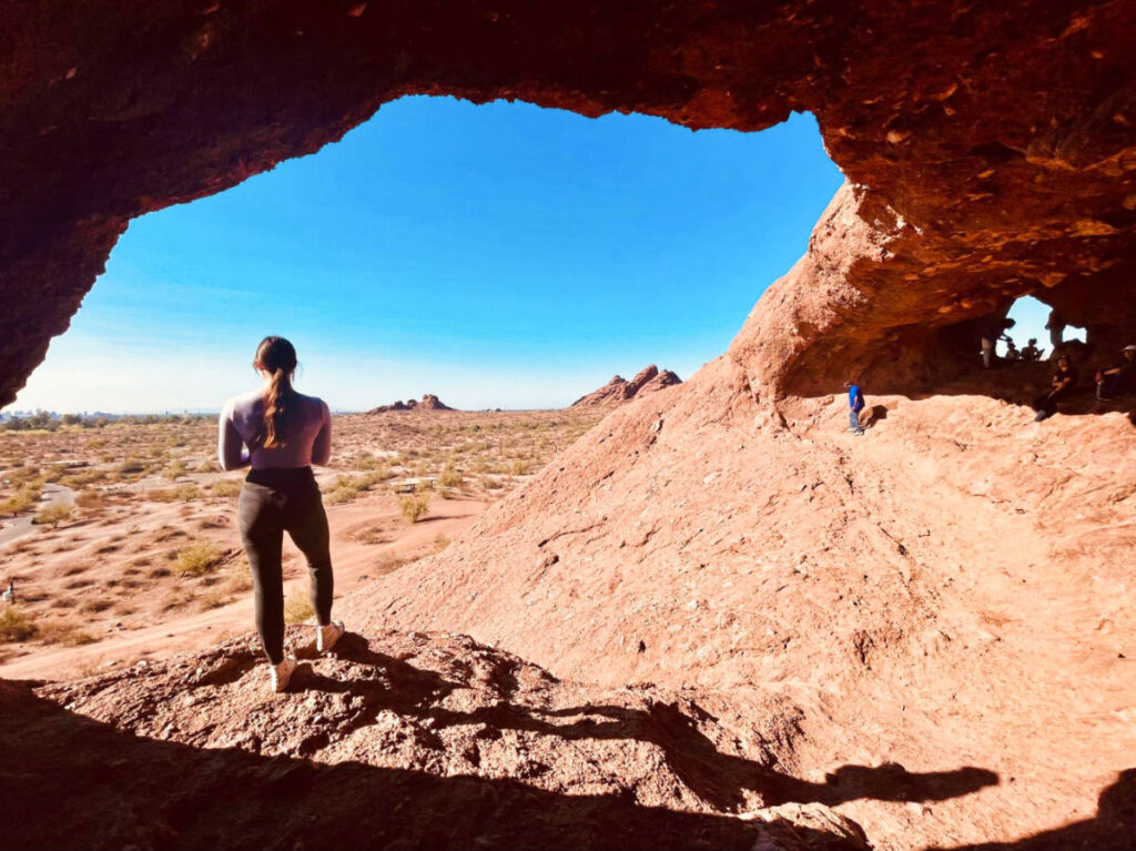 The author Betty Hurd, posing at the hole in the Rock Trail in Papago Park