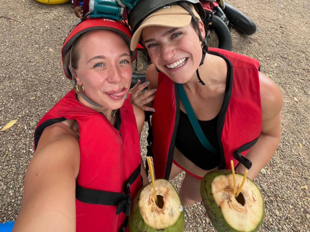 The author Betty Hurd and her friend drinking coconuts