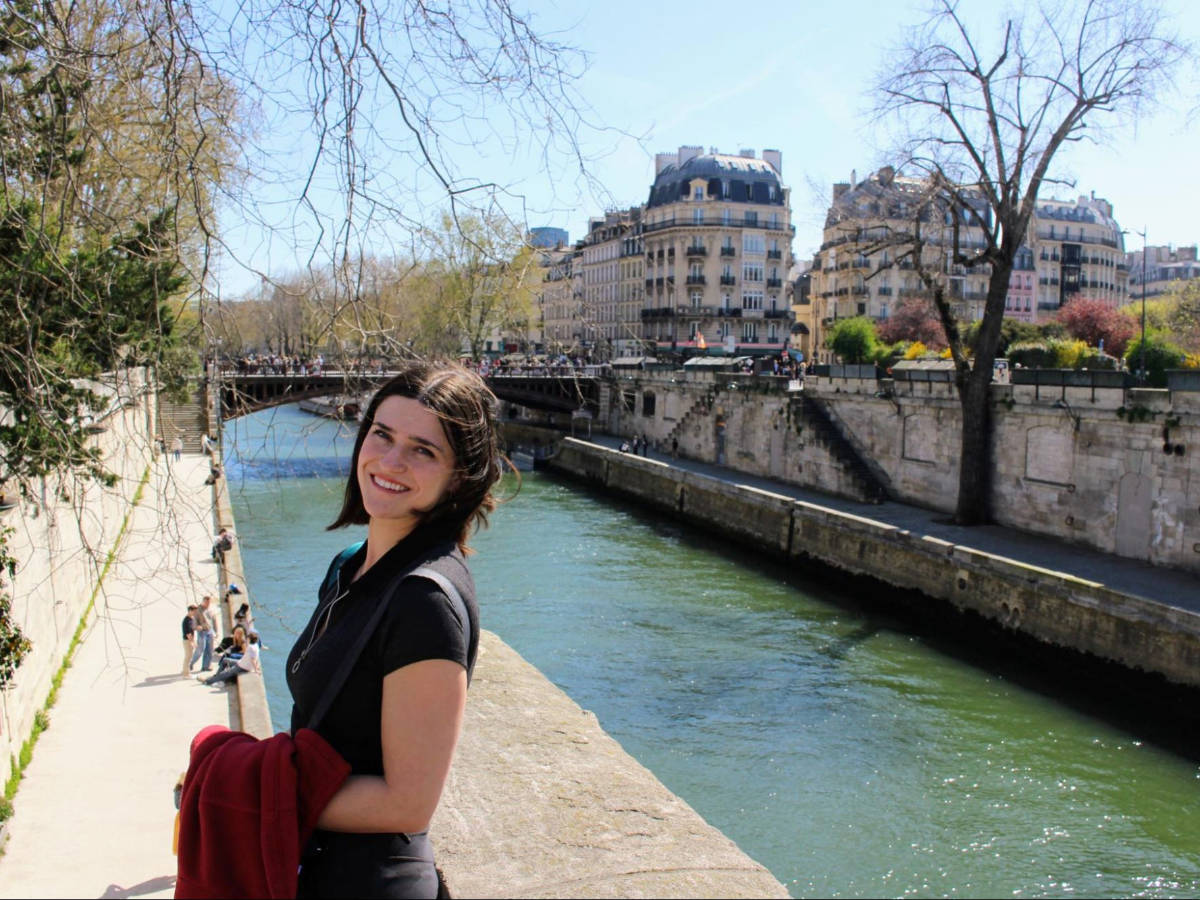 Travel Lemming writer Betty Hurd with the Seine River on her background