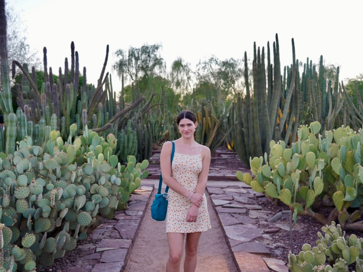 Author Betty standing in the middle of the cacti at Desert Botanical Gardens