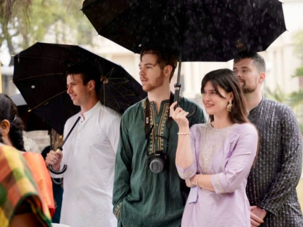 Betty at her cousin’s wedding holding an umbrella