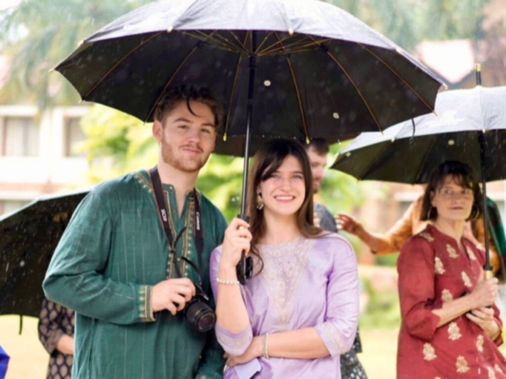 Betty holding an umbrella at the rainy wedding ceremonies