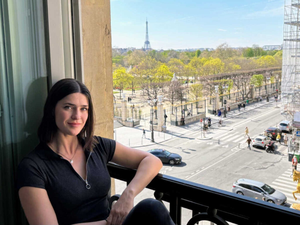 Travel Lemming Betty lounging in the window with Eiffel Tower view at Hotel Regina Louvre