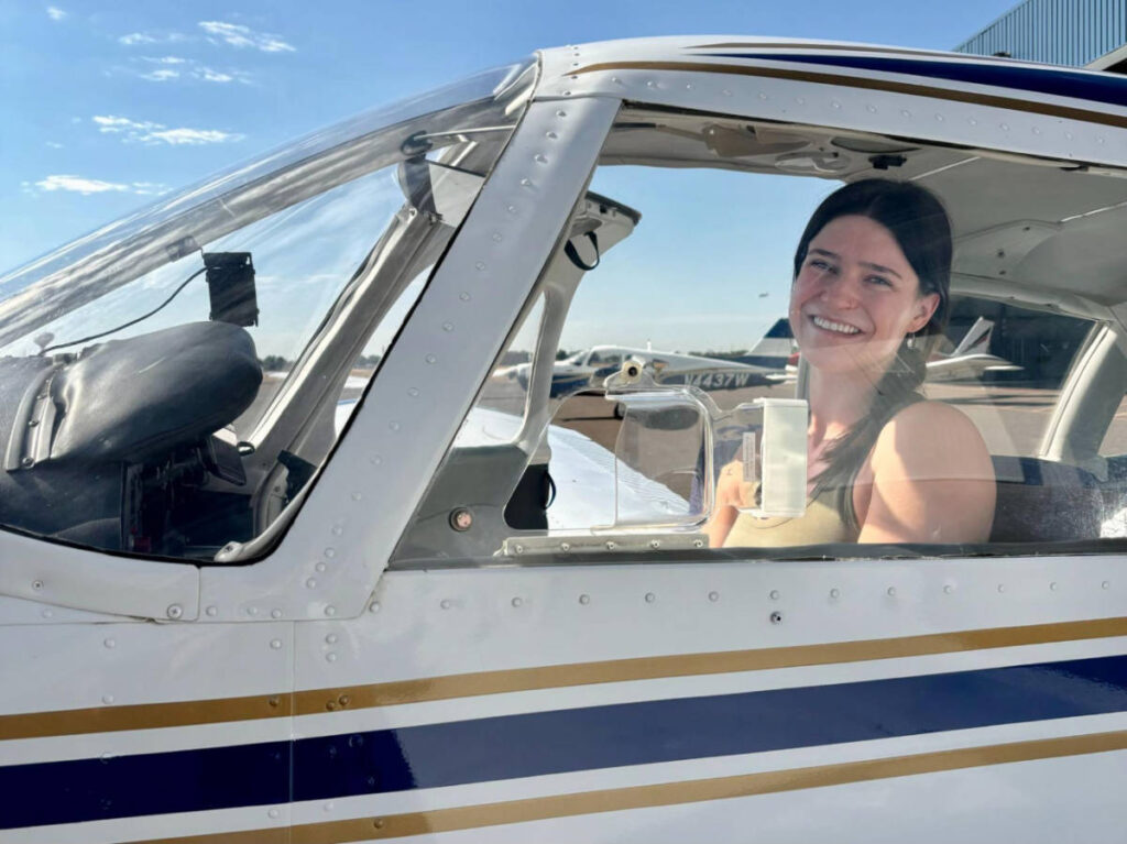 The author Betty Hurd on the front seat of an airplane