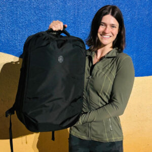 The author Betty Hurd holding the Tortuga Travel Backpack Lite 40L