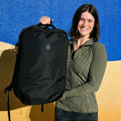 The author Betty Hurd holding the Tortuga Travel Backpack Lite 40L