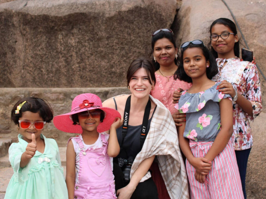 The author Betty Hurd smiling for a photo with an Indian family