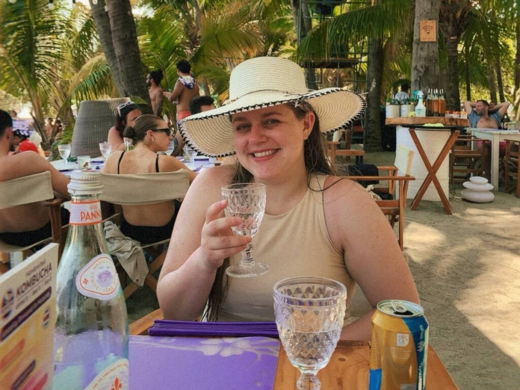 The author's friend drinking at the beach