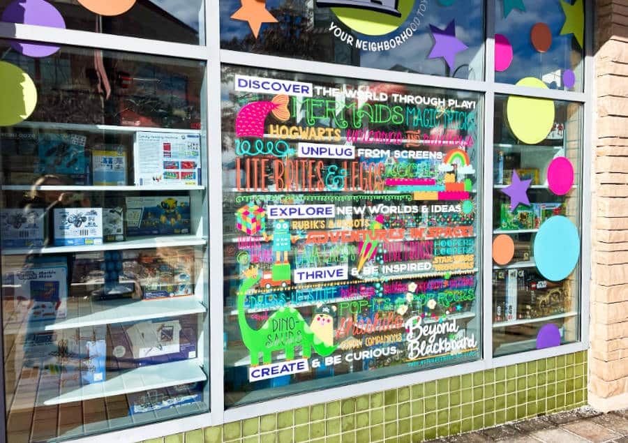 Colorful stickers on the glass window of Beyond the Blackboard