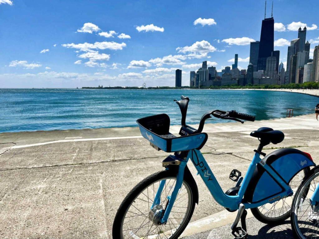A bicycle parked along the Lakefront Trail with the views of the city skyline