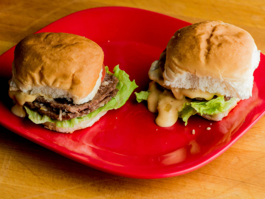 Burgers on a plate served in Big Apple Inn