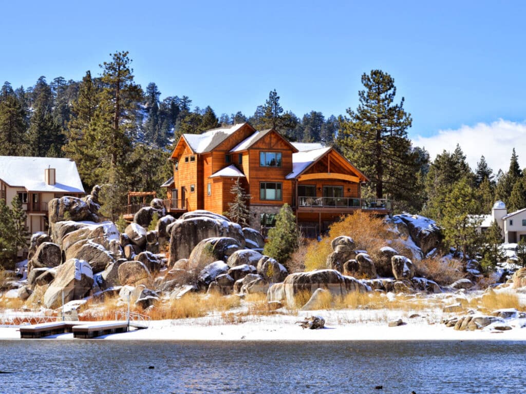 View of the cabins on the rocky hill from across the water in Big Bear