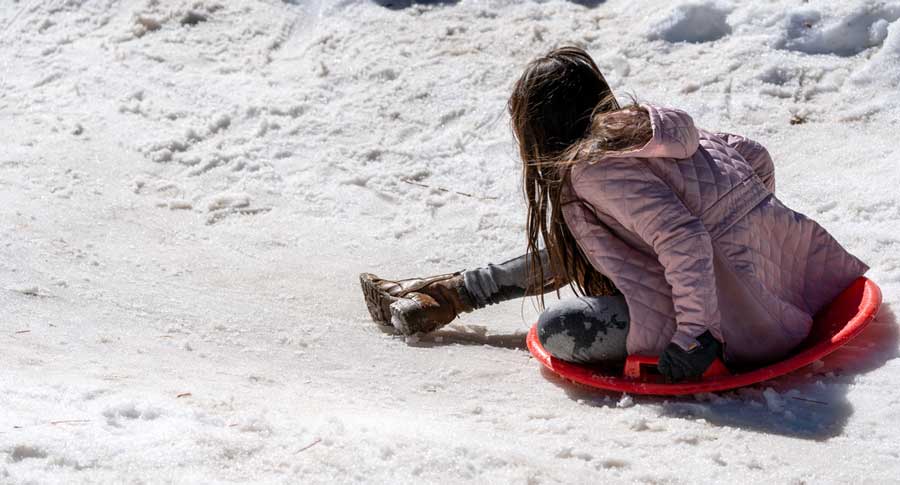 A girl sledding at Big Bear Snow Play in California