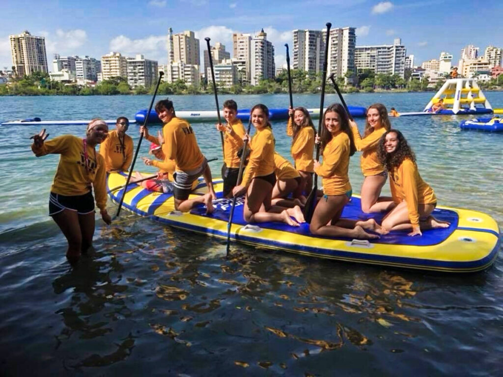 A group of people on a big paddleboard