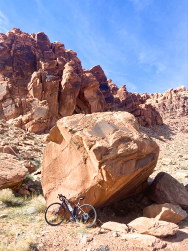 A bicycle parked against the Moab sandstone in Slickrock Bike Trail