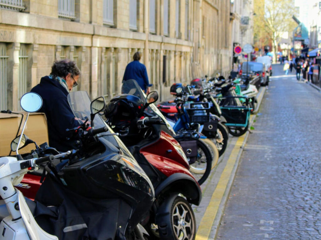 View of a street full of bikes and scooters in Montmartre