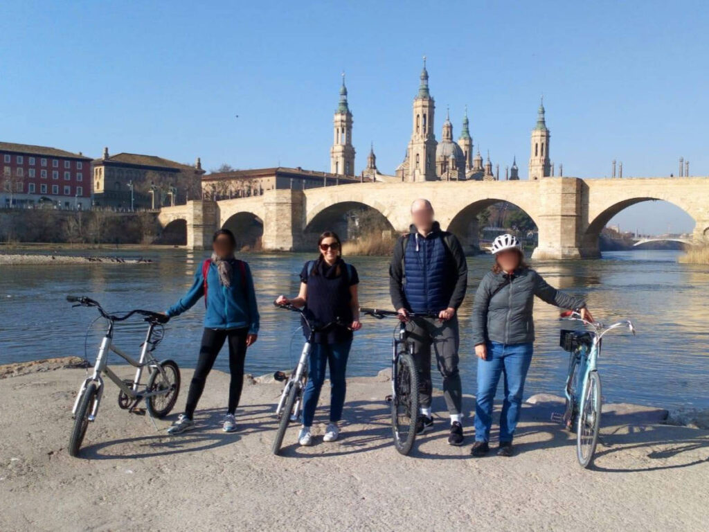 The author, Catherine Driver smiling for a photo while holding her bike at Ebro River
