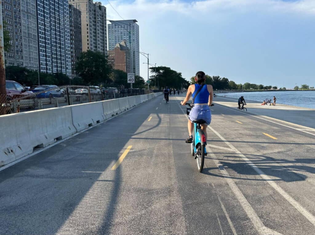 The author's friend biking during a sunny morning at the Lakefront Trail