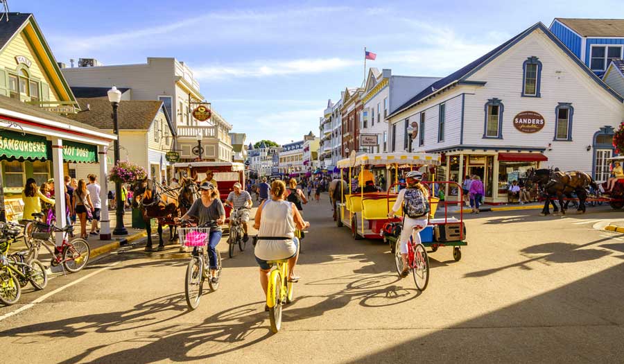 People biking on one of the streets on Mackinac Island