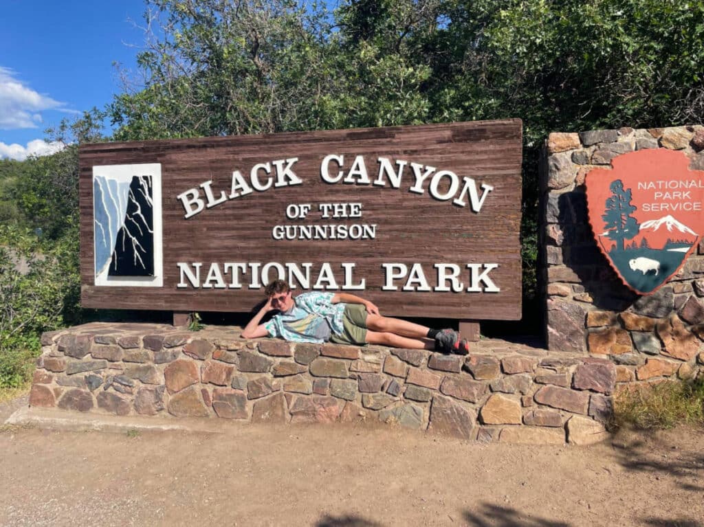 The author's son posing for a photo at the entrance of Black Canyon of the Gunnison National Park