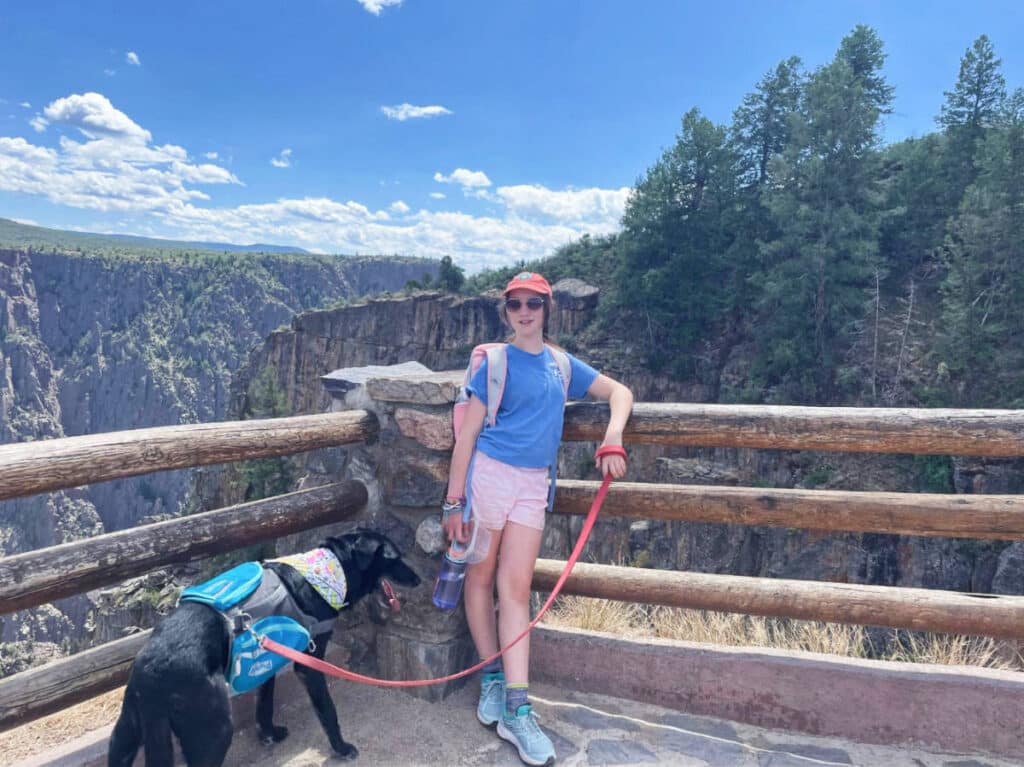 A girl with her dog at the Black Canyon of the Gunnison National Park during summer season