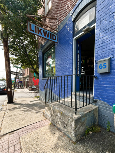 View of the signage and entryway of blue LIKWID building