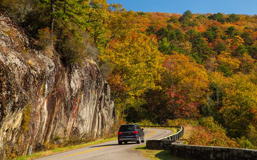 A car driving in Asheville with a view from Blue Ridge Parkway